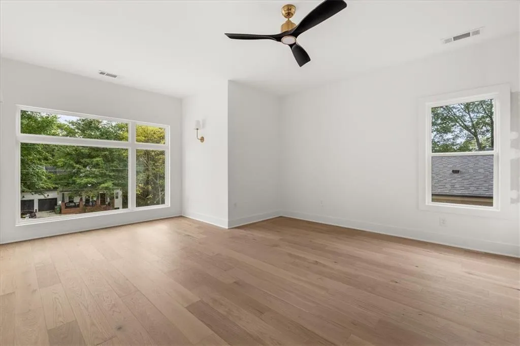 Empty room featuring light wood finished floors and ceiling fan