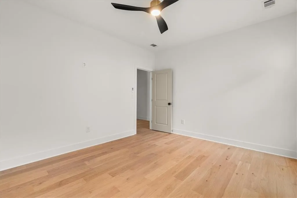 Spare room featuring light wood-type flooring and ceiling fan