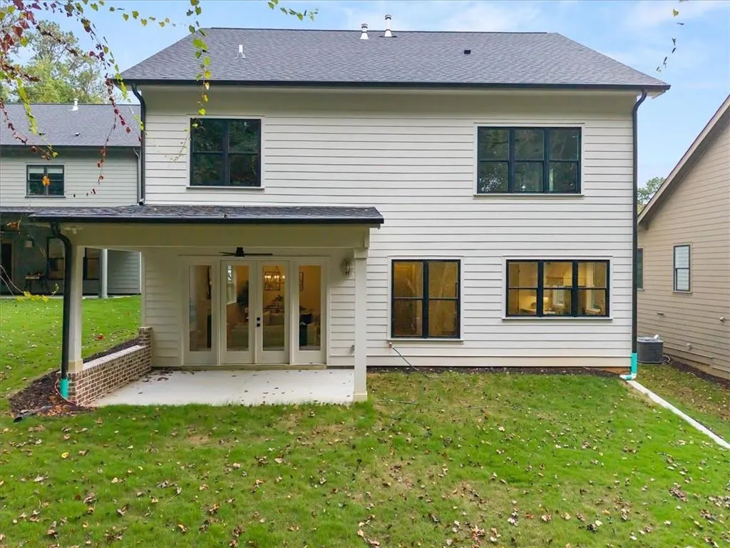 Back of property featuring a yard, a patio area, a ceiling fan, and french doors