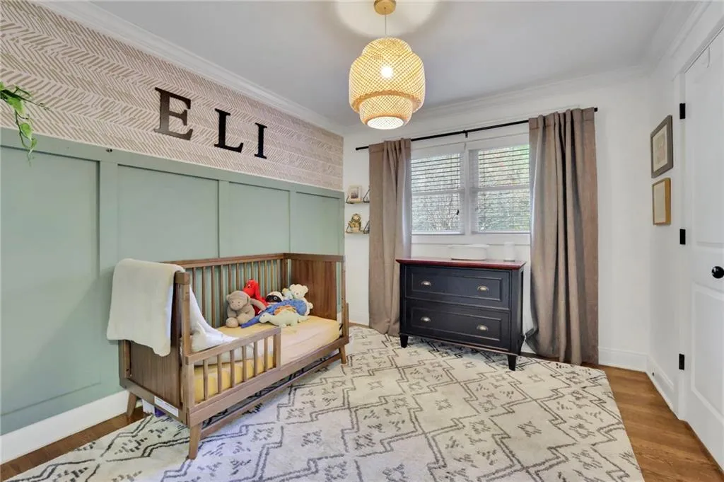 Bedroom with hardwood / wood-style floors and ornamental molding