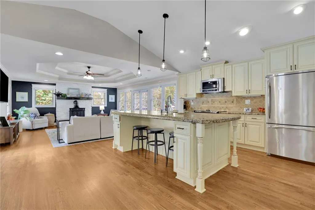 Kitchen featuring appliances with stainless steel finishes, a center island, plenty of natural light, and cream cabinets