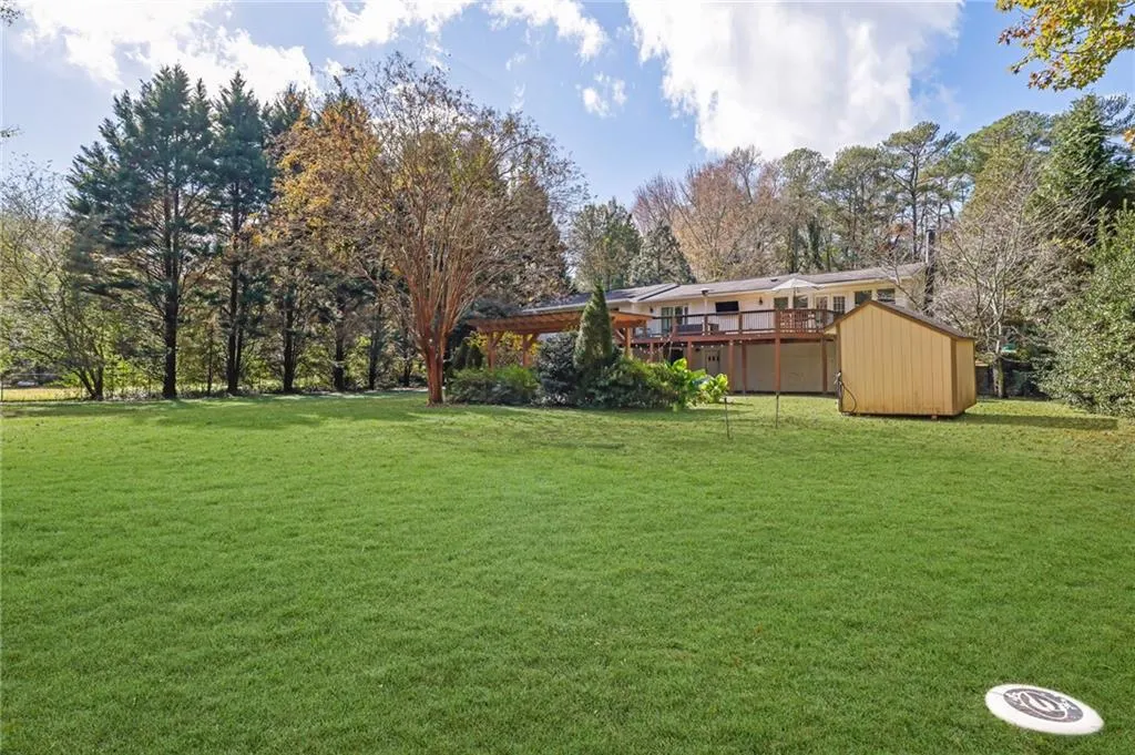 View of yard featuring a shed and a deck