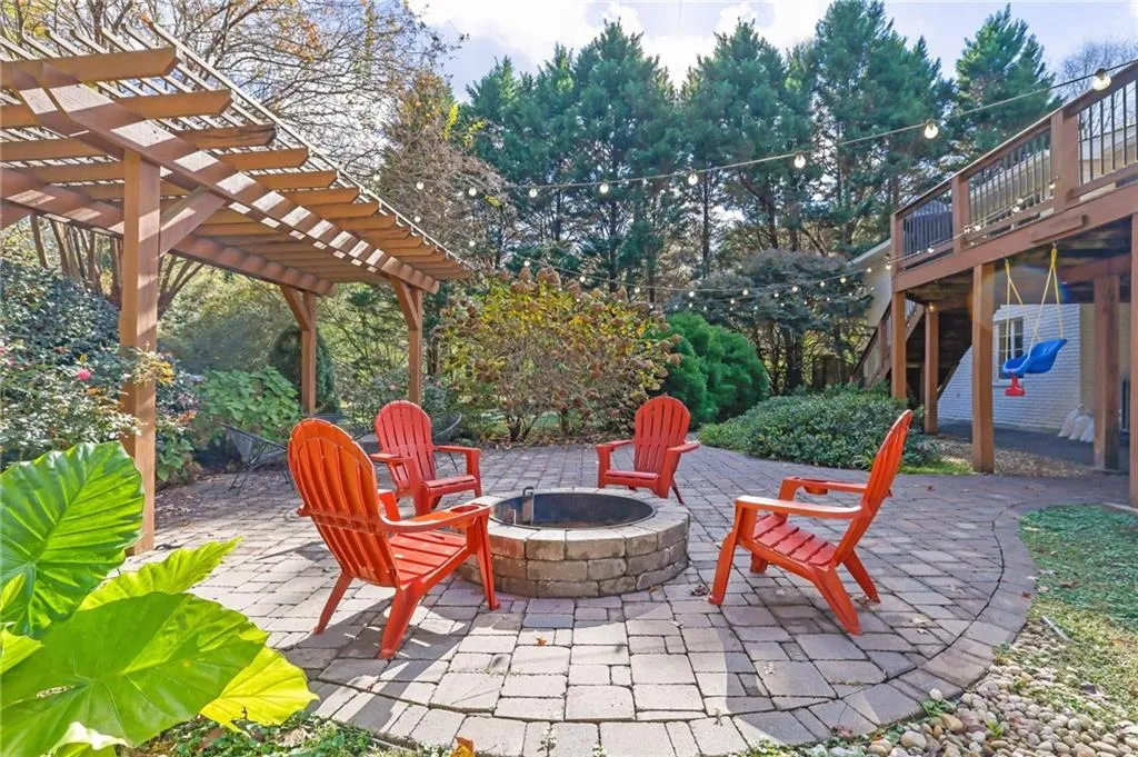 View of patio / terrace with a pergola, a fire pit, and a deck