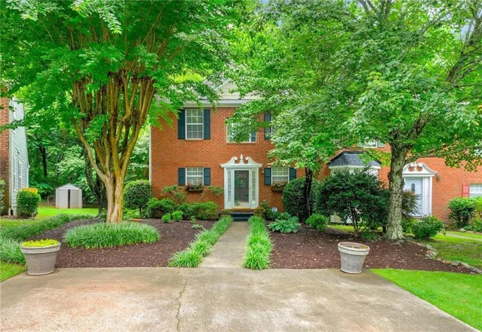 Brick exterior residence with a concrete driveway and walkway