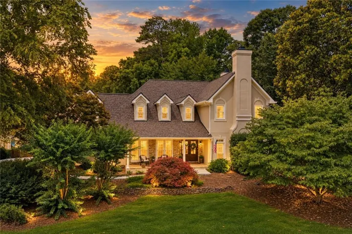 Hardcoat stucco exterior with a prominent chimney and multiple gabled dormer windows