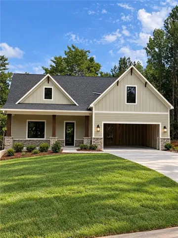 AI GENERATED   Craftsman-style exterior with board and batten siding, stone accents, and an attached two-car garage