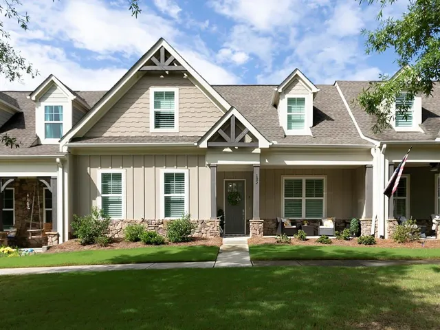 Contemporary exterior featuring vertical siding, shingle siding, and stone accents