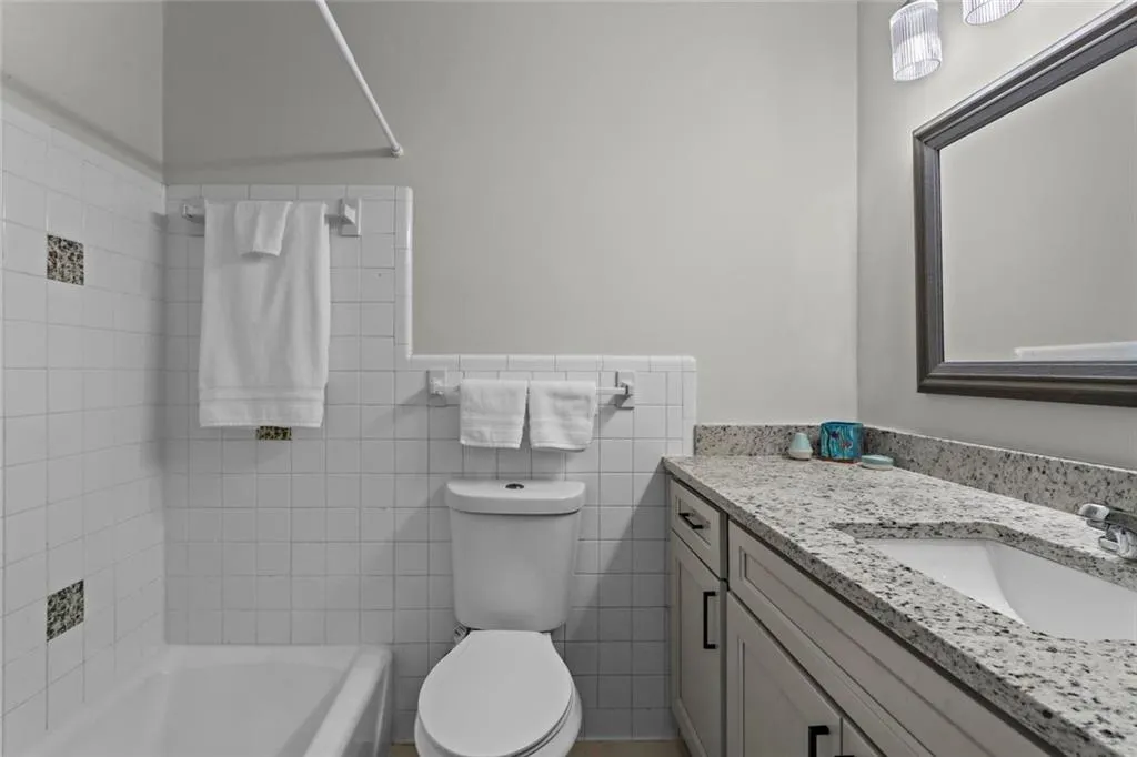 Updated vanity, countertop and toilet in full bathroom with tub/shower combo