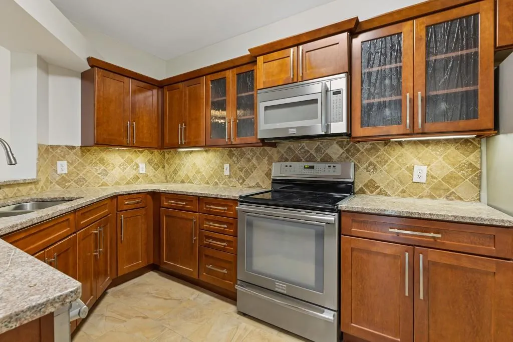 Kitchen with granite countertops and custom cabinetry