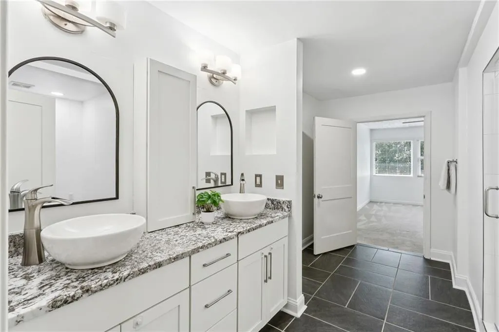 Owners primary bathroom with double vanity and brand new oversized shower.