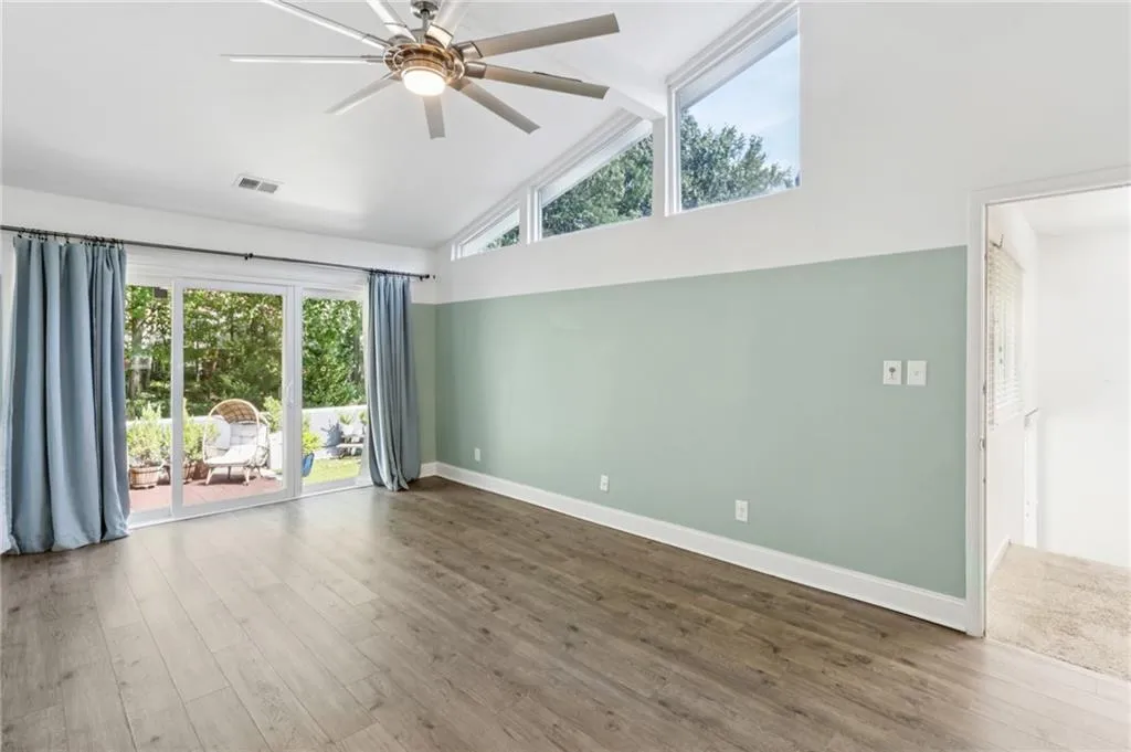 Large primary bedroom with vaulted ceiling.