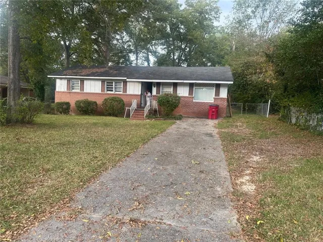 Single story home with a front lawn