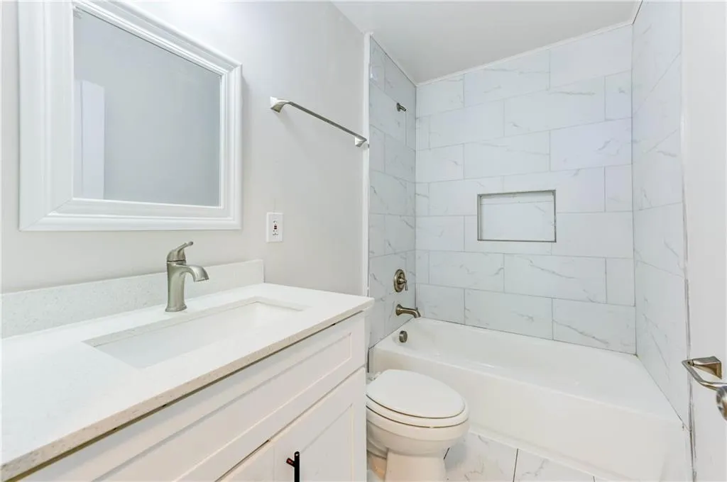 Full bathroom with shower / washtub combination and vanity