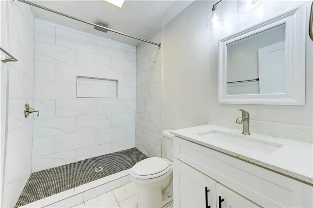 Full bathroom with a stall shower and vanity