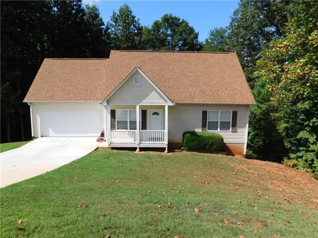 Light-colored siding exterior with a contrasting brown roof