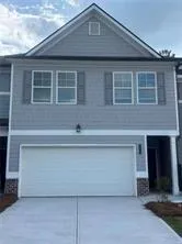 View of front of home with an attached garage and concrete driveway