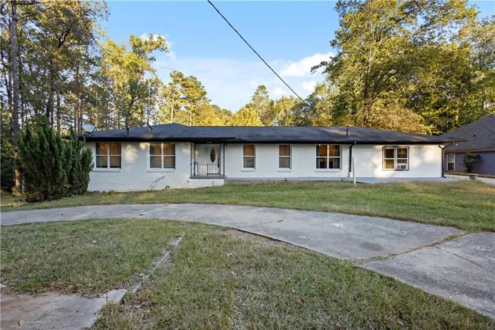 Single story home with a front yard and brick siding
