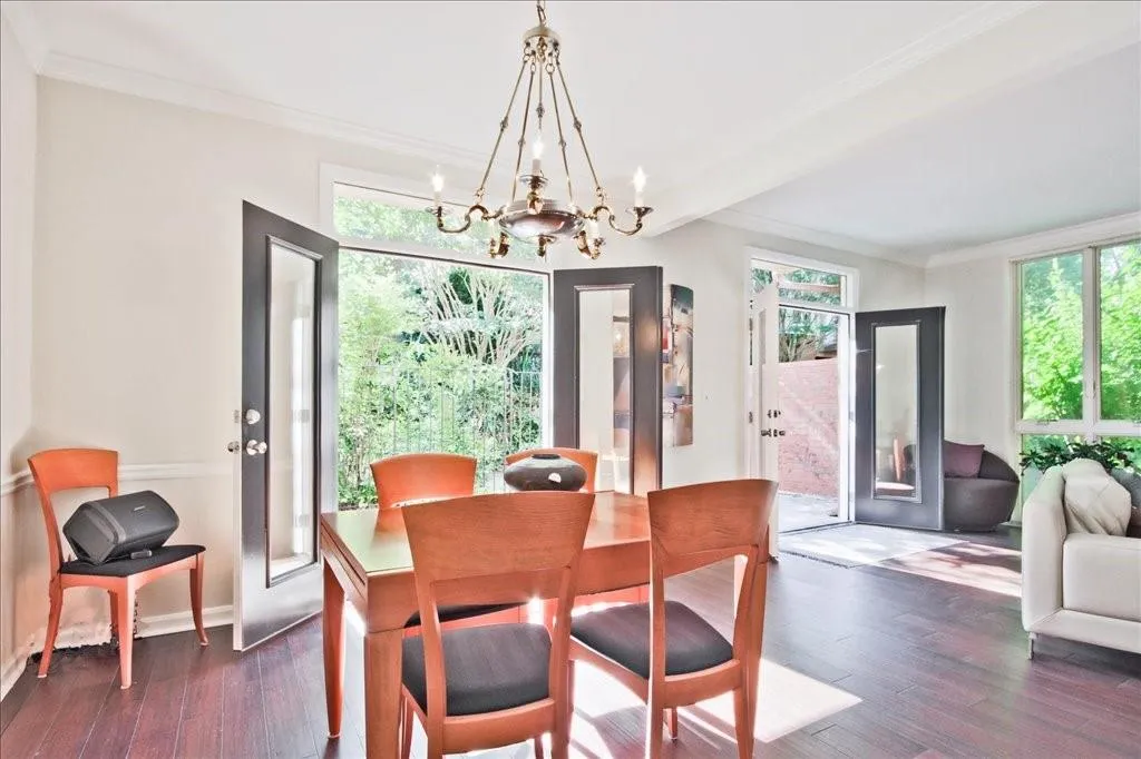 Dining space featuring a chandelier, crown molding, and dark hardwood / wood-style flooring