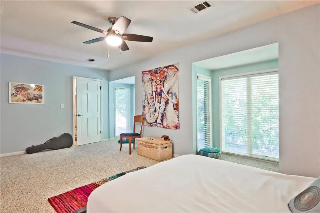 Bedroom featuring ceiling fan and carpet flooring