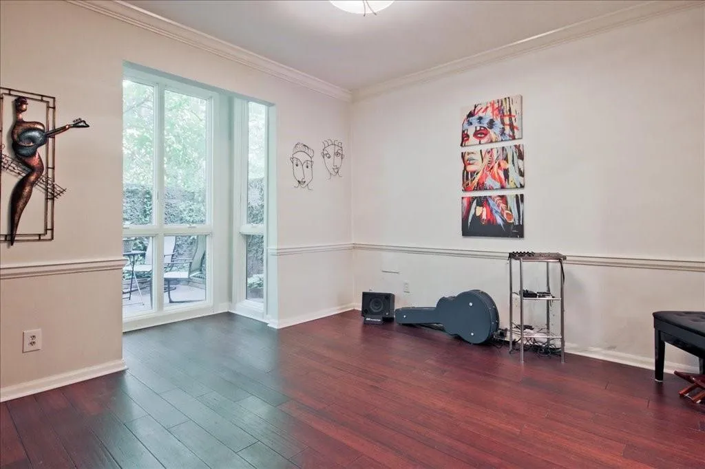 Workout area featuring dark hardwood / wood-style flooring and ornamental molding