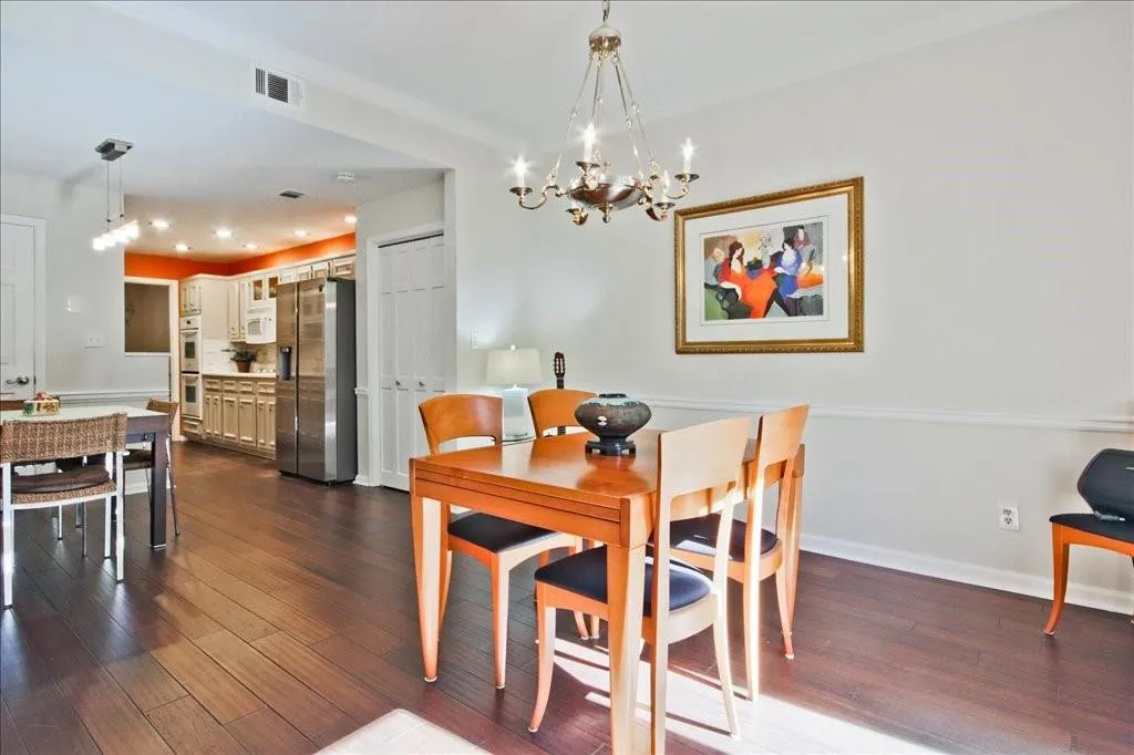 Dining area featuring dark hardwood / wood-style floors and a notable chandelier