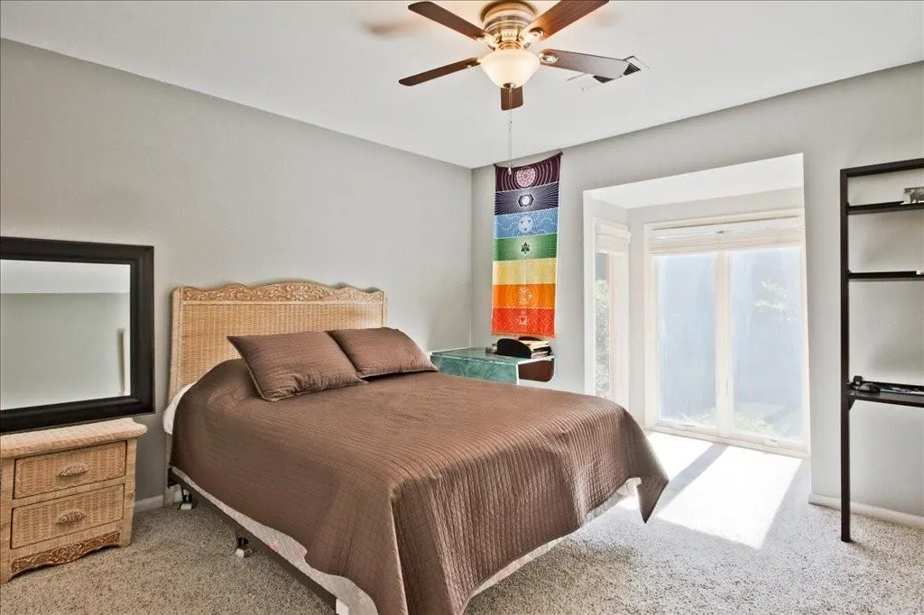 Bedroom featuring ceiling fan and carpet flooring