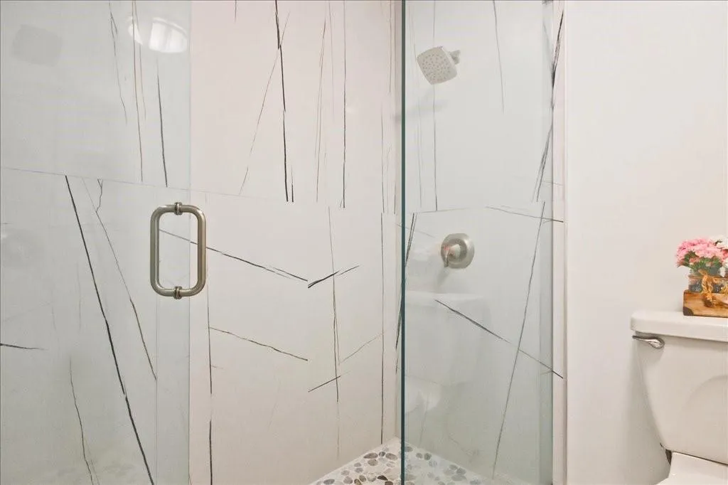 Bathroom with toilet and a shower with door