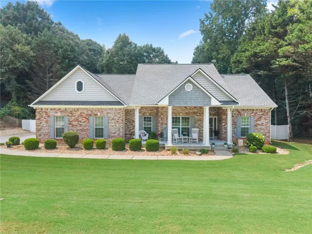 Brick exterior with gabled roof lines and shingle siding accents