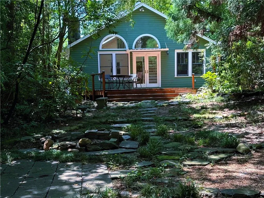 View of front of house featuring a deck and french doors