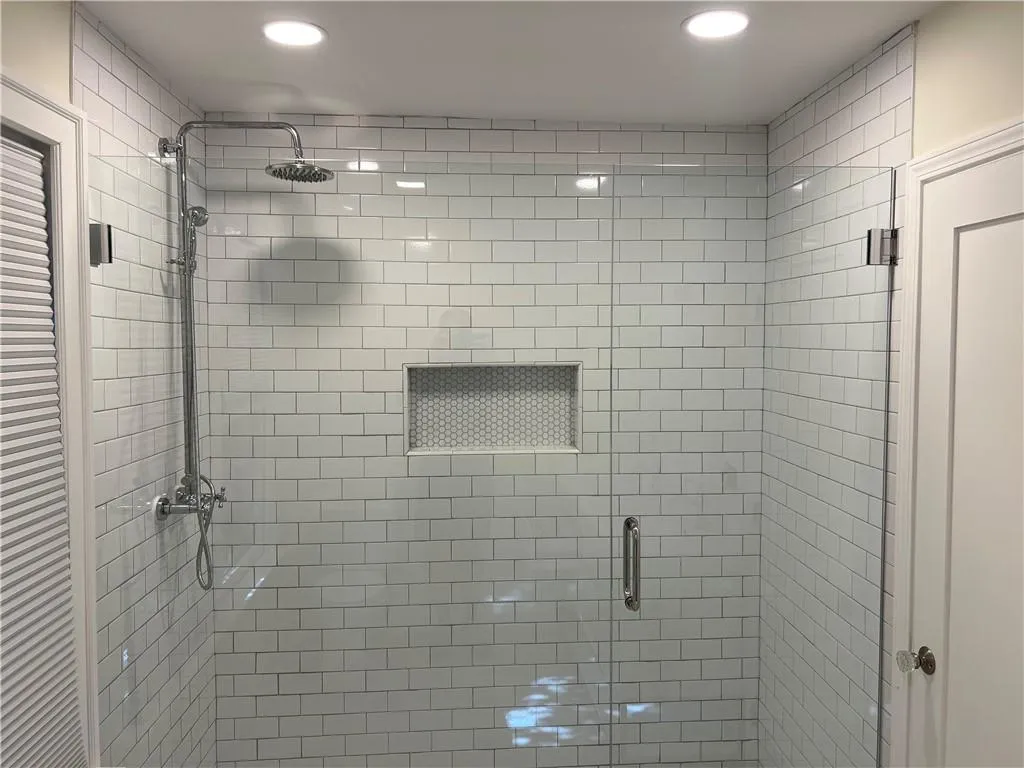 Full bath with a shower stall and recessed lighting