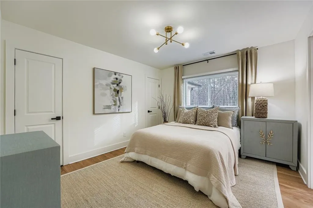 Bedroom featuring a chandelier and light wood-style flooring