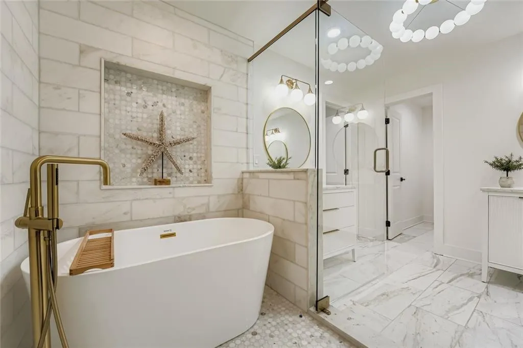 Bathroom with vanity, a soaking tub, marble look tile flooring, and tile walls
