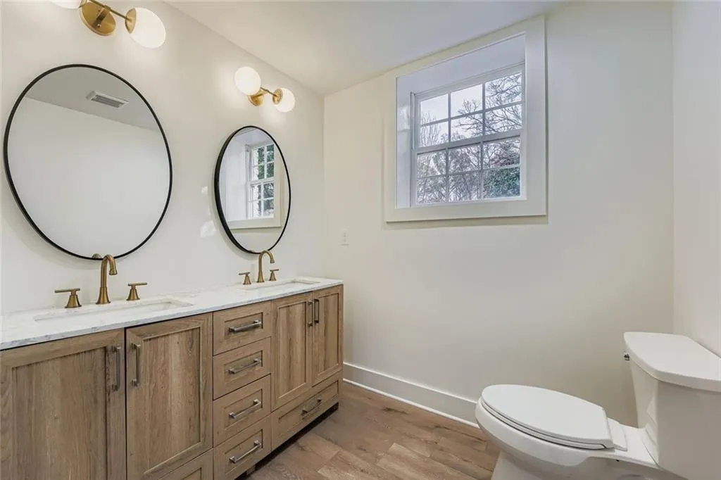 Bathroom with light wood-style flooring and double vanity