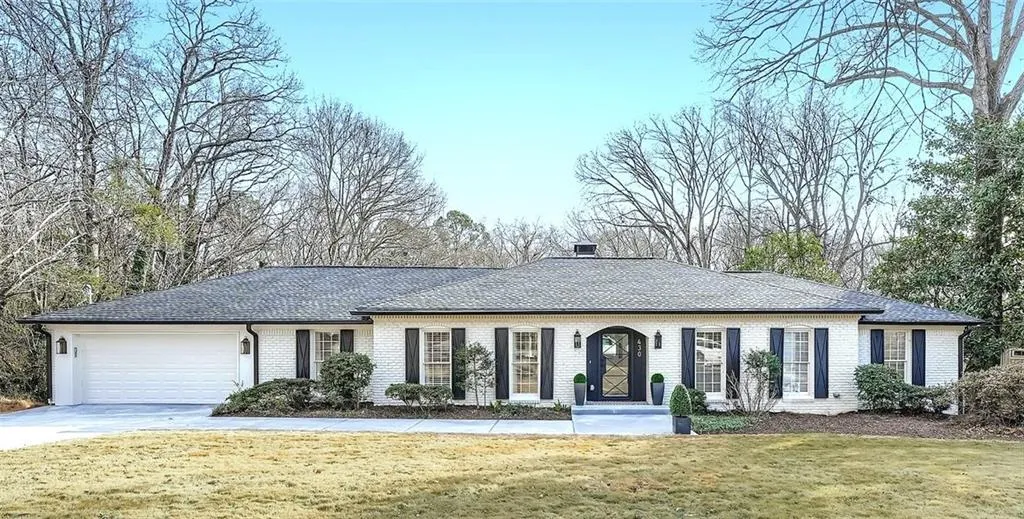 Single story home featuring roof with shingles, brick siding, a front yard, and concrete driveway