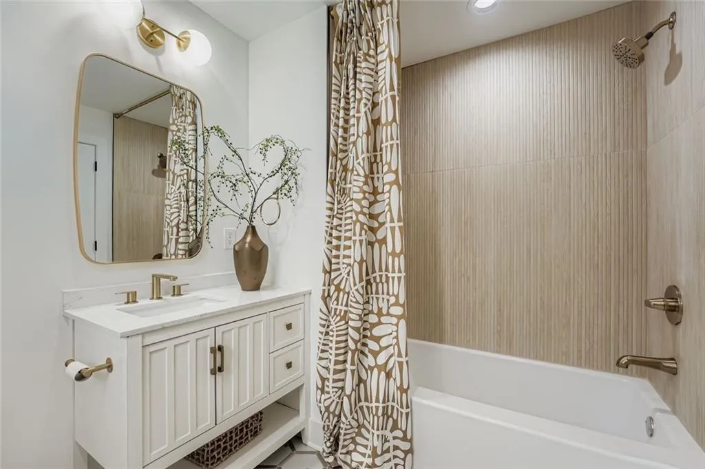 Bathroom featuring vanity and shower / bath combo with shower curtain
