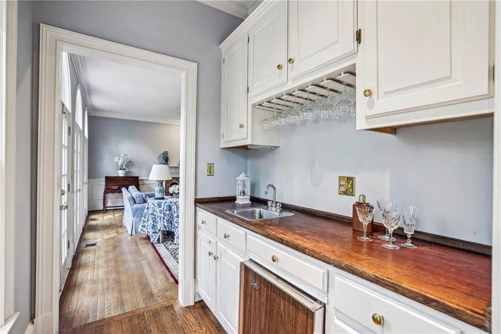 Wet bar with built ins and bar refrigerator, connects kitchen and family room.