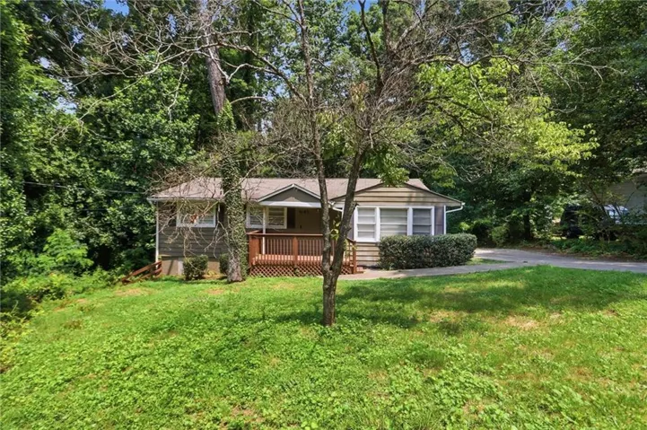 Charming bungalow-style residence featuring natural wood siding and a covered front porch