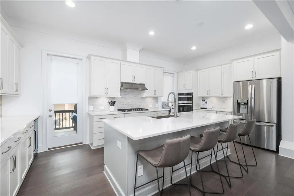 Stainless appliances, luxury quartz, two doors to outside living space right off the kitchen - perfect for entertaining