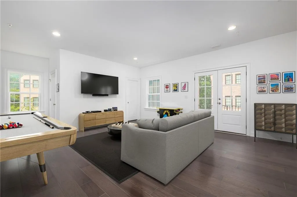 Virtually staged garage level media room to show potential