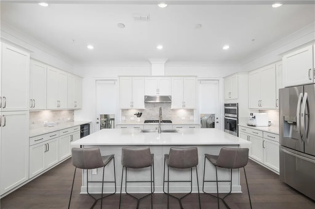 Oversized quartz topped island overlooking chef's kitchen