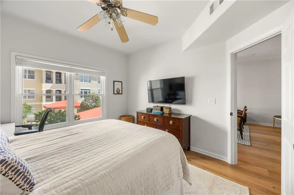 Bedroom with light wood-style floors and a ceiling fan