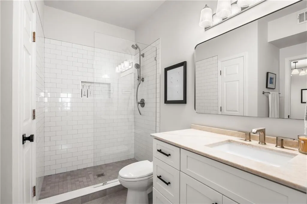 Full bath featuring vanity and a shower stall