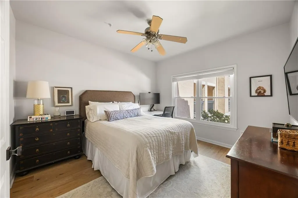 Bedroom with light wood-type flooring and a ceiling fan
