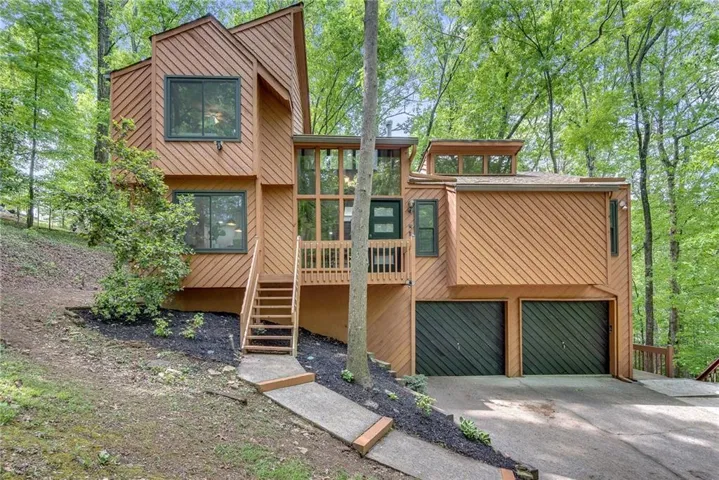 Contemporary exterior featuring wood-tone siding and a multi-level design