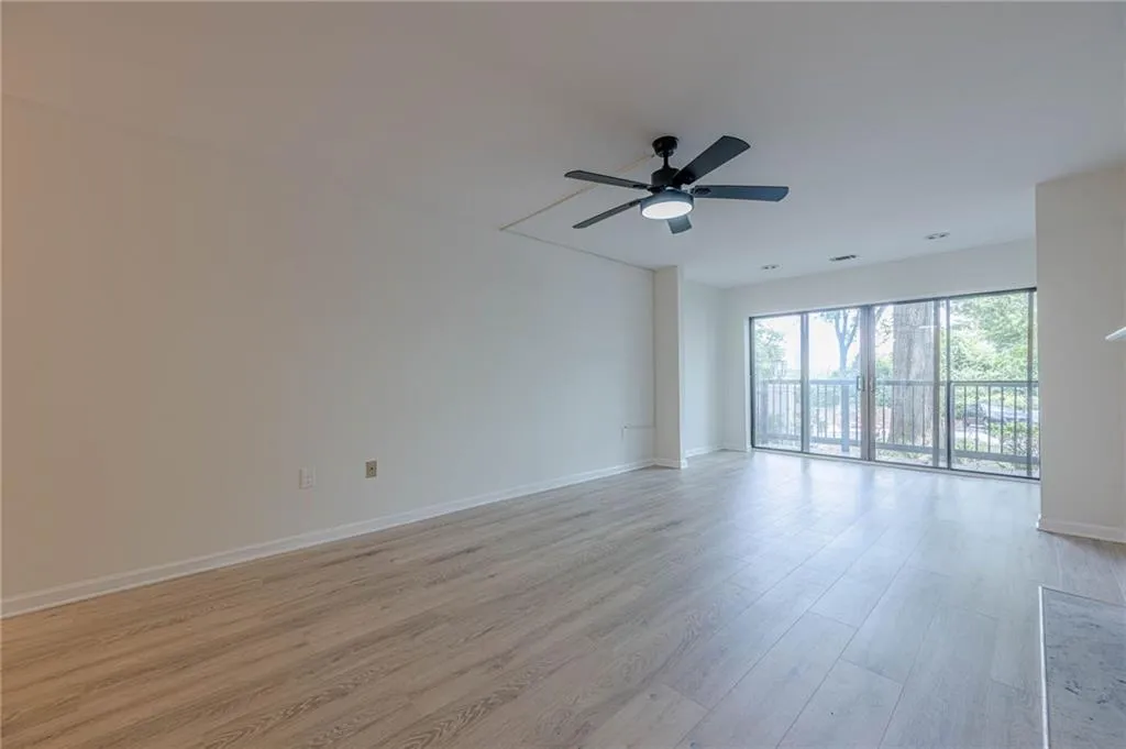 Empty room with light wood-type flooring and a ceiling fan