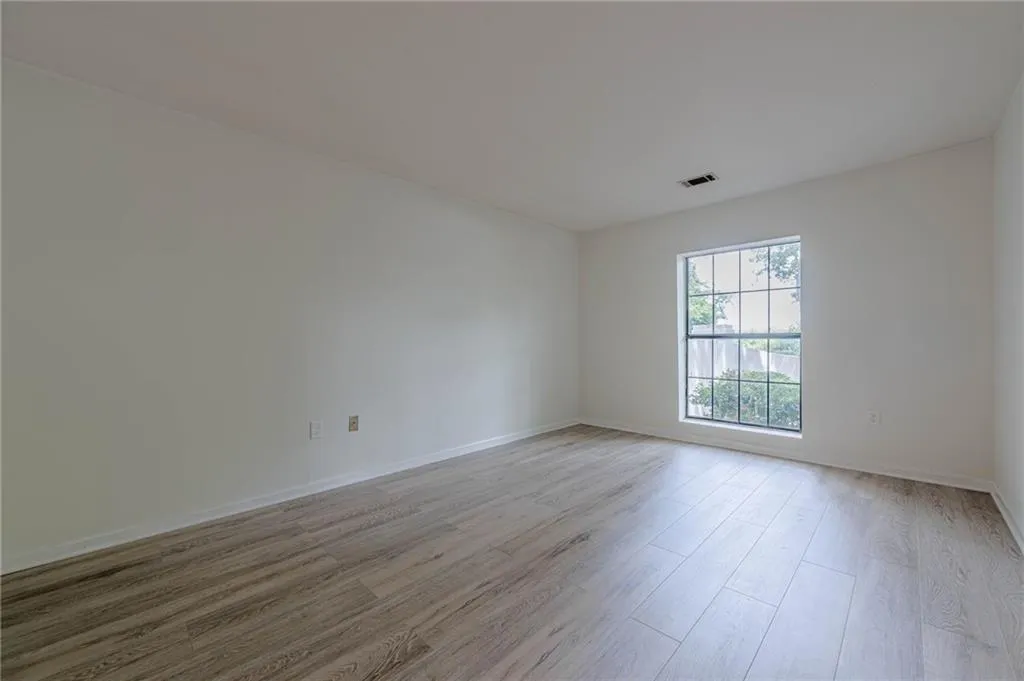 Empty room with light wood-style flooring and baseboards