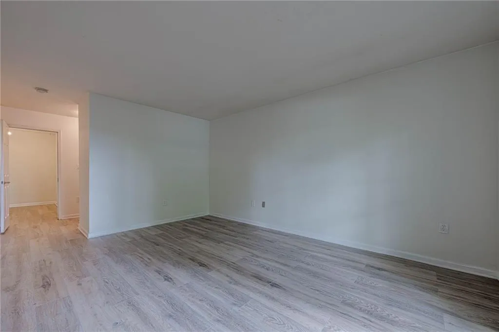 Unfurnished room featuring light wood-style flooring and baseboards