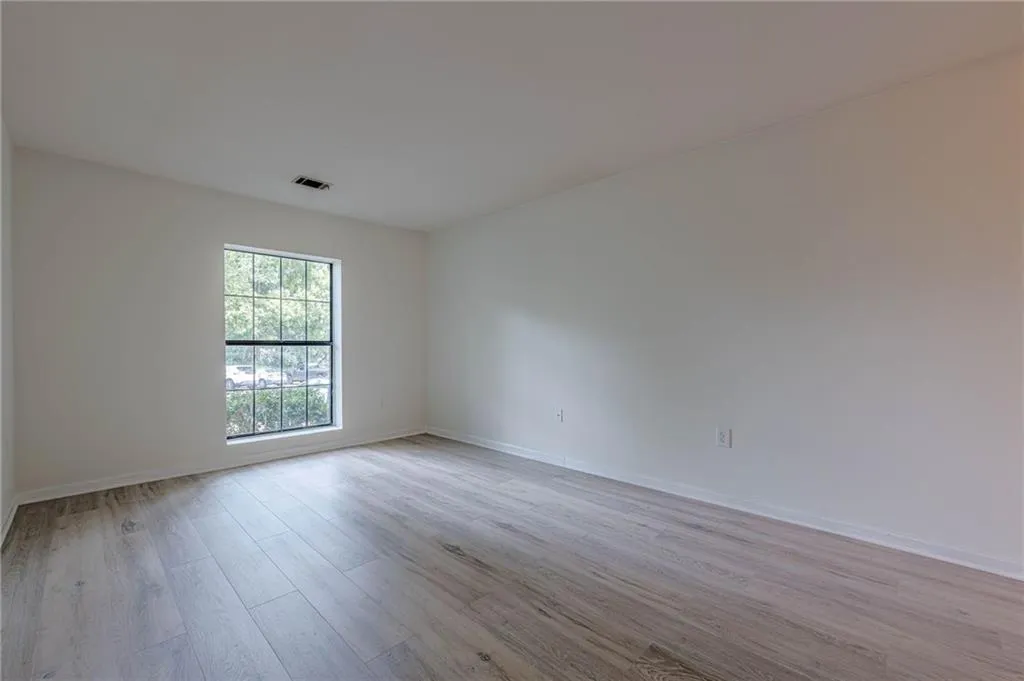 Empty room with light wood-style floors and baseboards