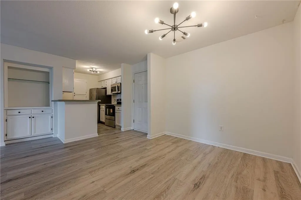 Unfurnished living room featuring a chandelier and light wood finished floors