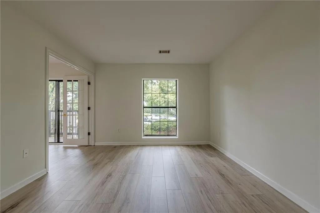 Unfurnished room featuring light wood-style flooring and baseboards